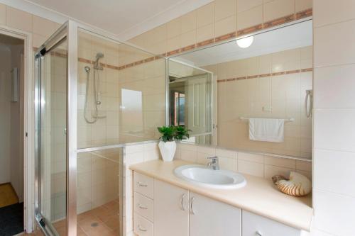 a bathroom with a sink and a shower at Bella Vista Townhouse with Views in Spearwood