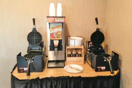 a table with two machines on top of it at La Quinta Inn by Wyndham Detroit Southgate in Southgate