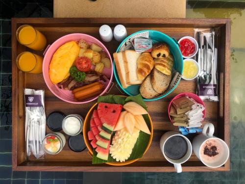 a tray filled with different types of breakfast foods at Avani Ao Nang Cliff Krabi Resort in Ao Nang Beach