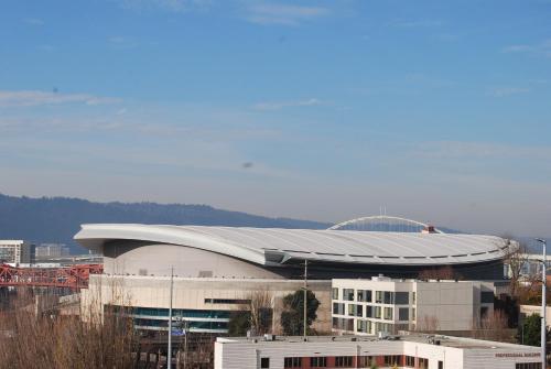 a large building with a curved roof in a city at Inn at the Convention Center in Portland