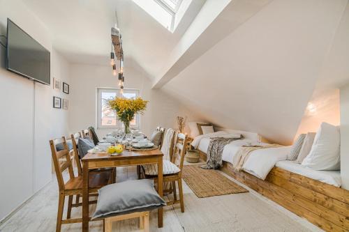 a dining room with a table and a couch at APTs in OLD TOWN PRAGUE by Michal&Friends in Prague