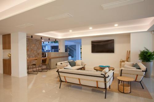 a living room with couches and a table at Hotel MiM Mallorca & Spa - Adults Only in Sa Coma