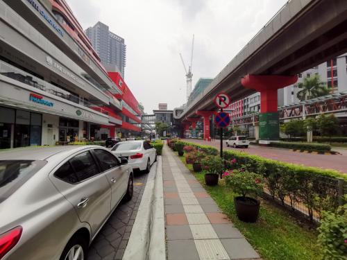 two cars parked on the side of a city street at Infistay Homestay - Sunway Geo Avenue, Sunway Pyramid, Sunway Lagoon, Sunway University, Sunway Medical Centre in Subang Jaya