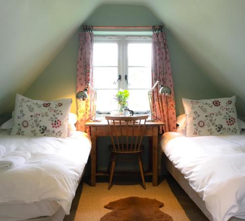 A bed or beds in a room at Starnash Farmhouse 