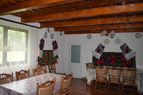 a dining room with christmas decorations on the walls at La Vasile la Cazan in Mara