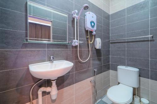 a bathroom with a sink and a toilet at Super OYO 89807 My Budget Home in Batu Ferringhi