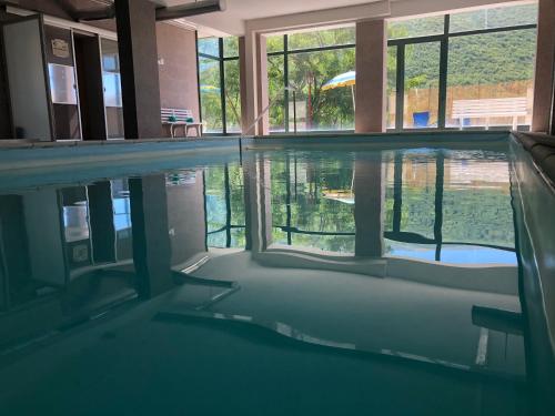 an empty swimming pool with a view of the water at Hotel Campo Felice in Lucoli Alto