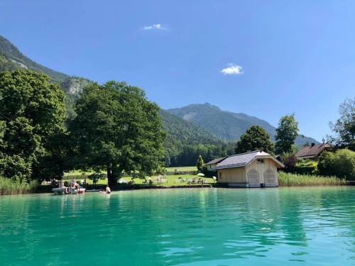 a house in the middle of a large body of water at Landhaus Leopoldhof in St. Wolfgang