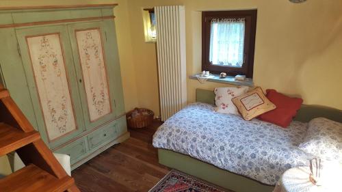 a small bedroom with a bed and a window at HOME SWEET HOME in Antey-Saint-André