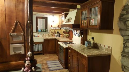 a kitchen with wooden cabinets and a stove top oven at HOME SWEET HOME in Antey-Saint-André
