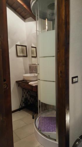 a bathroom with a sink and a white refrigerator at HOME SWEET HOME in Antey-Saint-André