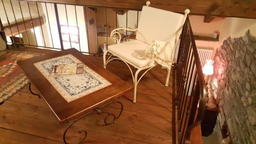 a room with a chair and a table with a book at HOME SWEET HOME in Antey-Saint-André