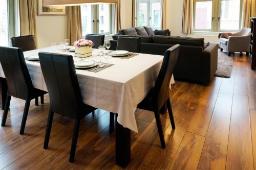 a dining room with a table with a white table cloth at Apartments Ypres in Ypres