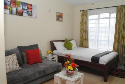 Кровать или кровати в номере West suite Sherry homes, Kisauni Road Nairobi West