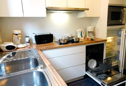 a small kitchen with a sink and a stove at Apartments Ypres in Ypres