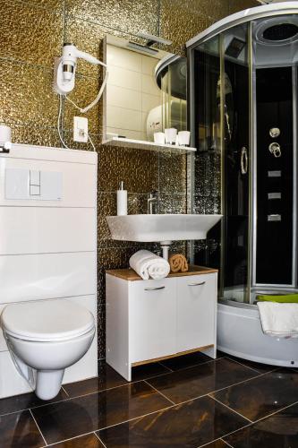 a bathroom with a toilet and a sink and a shower at Tamaris in Sevid