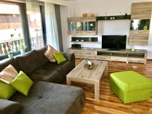 a living room with a couch and a table at Ferienhaus 1 An der Rodach in Steinwiesen