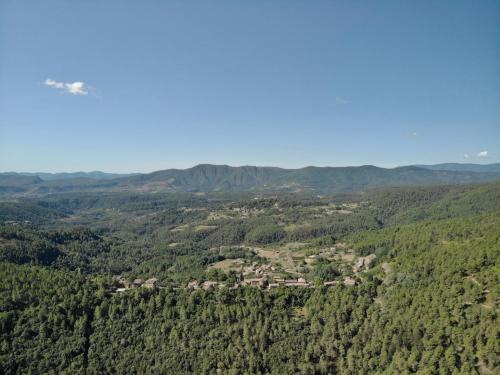 an aerial view of a village in a forest at Gîte du tilleul - 2 étoiles - domaine de l'olivier in Faugères