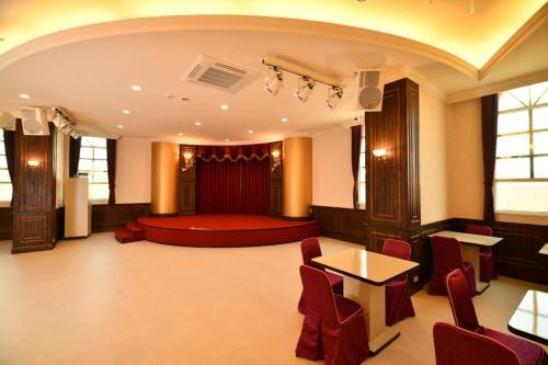 a large room with a bed and a table and chairs at Chuan Cheng Castle in Magong
