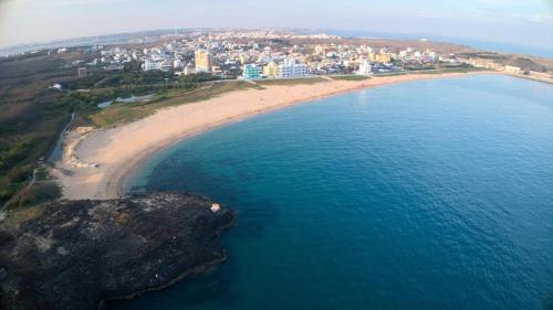 an aerial view of a beach next to the ocean at Chuan Cheng Castle in Magong