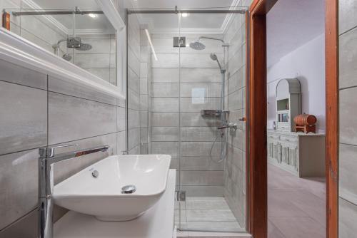 a bathroom with a sink and a shower at Windmill Villa in Kalyves Poligirou