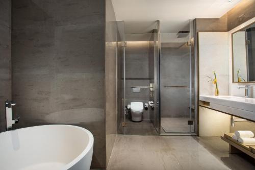a bathroom with a tub and a toilet and a sink at Crowne Plaza Fuzhou South by IHG in Fuzhou