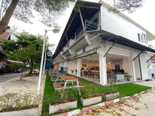 a building with a table and benches in front of it at Island Dive Club in Koh Tao