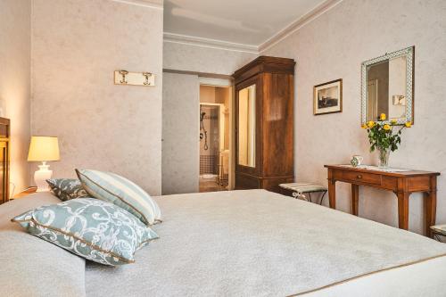 a bedroom with a bed with pillows and a table at Locanda De' Ciompi in Florence