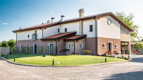 a large house with a yard in front of it at Agriturismo Casale ai Prati in Latisana