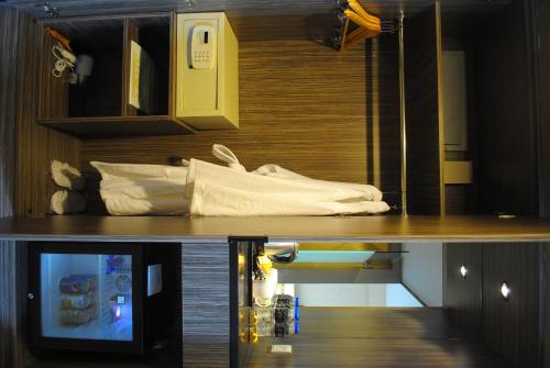 a room with a table with a tv on it at Grand Alora Hotel in Alor Setar