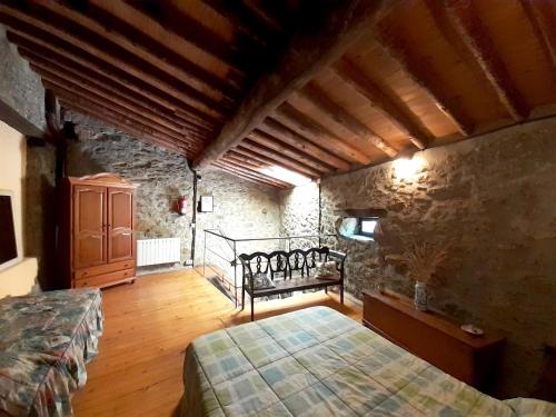 a bedroom with a bed and a stone wall at El Embalse in Los Loros
