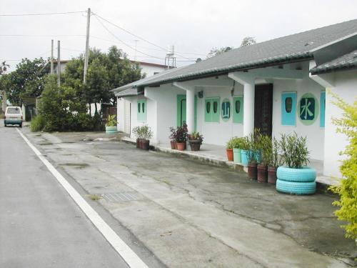 a row of houses with plants on the side of a street at Good Day B&B in Fengli