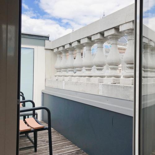 a balcony with a table and a chair at Callas House in Budapest