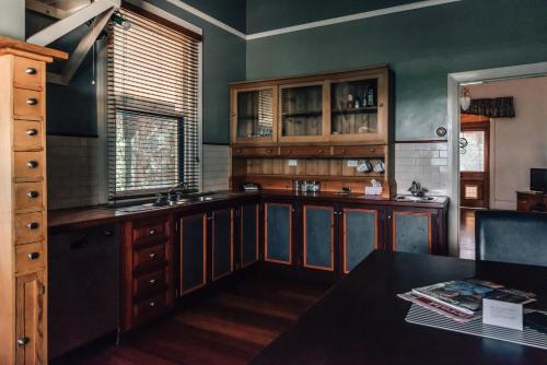 a large kitchen with wooden cabinets and a table at Barossa Dreams in Tanunda