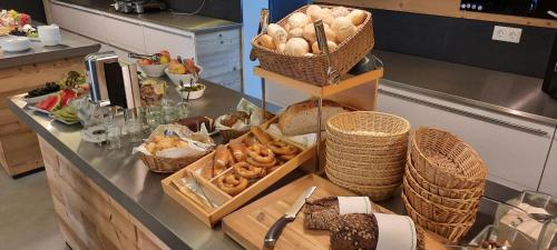 a counter in a kitchen with bread and baskets at Apartmenthotel Oberstdorf in Oberstdorf