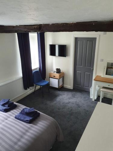 a bedroom with a bed and a desk and a chair at Red Lion Rooms - Self Check In in Dalton in Furness