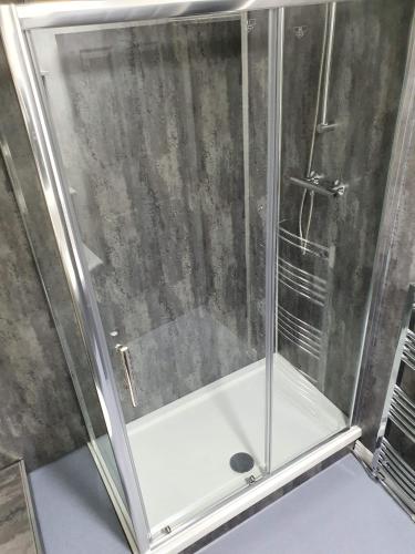 a shower with a glass door in a bathroom at Red Lion Rooms - Self Check In in Dalton in Furness