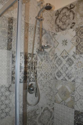 a shower with a shower head in a bathroom at B&B Le Fate in Sonnino