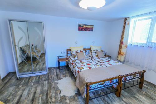 a bedroom with a bed and a large window at NIKAS APARTMENT in Sibiu