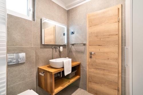 a bathroom with a sink and a mirror at CAPRARIA appartments in historic center, with private parking in Koper