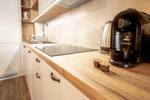 a kitchen with a sink and a coffee maker on a counter at Szpitalna 9 Residence in Kraków