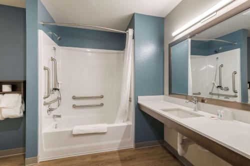 a bathroom with a shower and a sink at WoodSpring Suites Colton in Colton