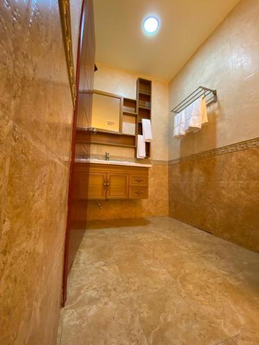 a bathroom with a shower and a sink at Rindali - The speedboat from Malé to the hotel departs at 1130 every Monday Thursday and Saturday and from the hotel to Malé at 0630 and five domestic flights are available every day in Dhaalu Atoll