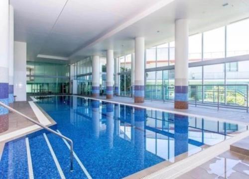 a large swimming pool with blue water in a building at Marina ocean view at Shores Southport in Gold Coast