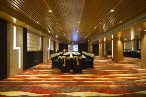 a conference room with a table and chairs on a carpet at The Fern Residency - Chandigarh in Chandīgarh