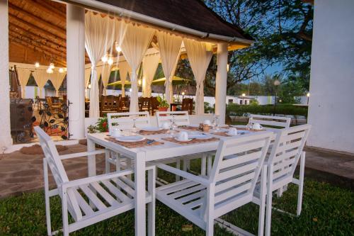 a white table and chairs on a patio at Villa Ameera Malindi in Malindi