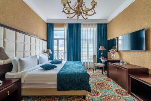 a hotel room with a large bed and a desk at Nevskiy Eclectic by AKYAN in Saint Petersburg