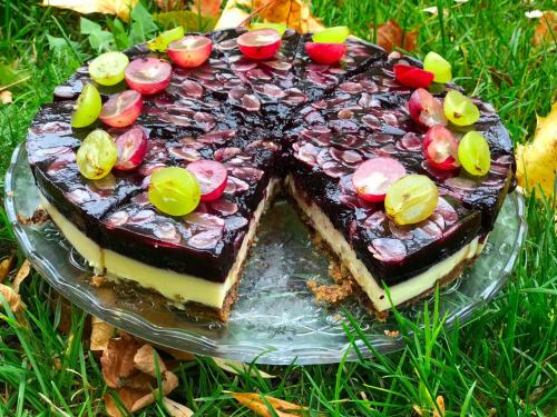 a chocolate cake on a glass plate in the grass at Hotel Rezident in Turčianske Teplice