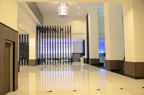 a lobby with a chandelier in the middle of a building at Grand Alora Hotel in Alor Setar