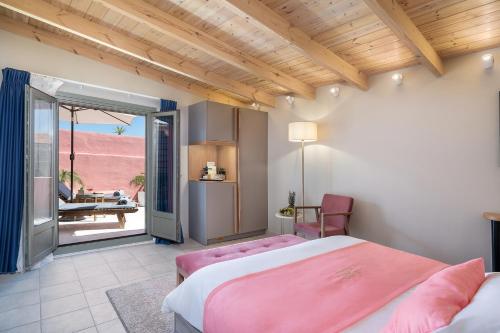 a bedroom with two beds and a view of the desert at Viaggio Elegant Rooms in Chania